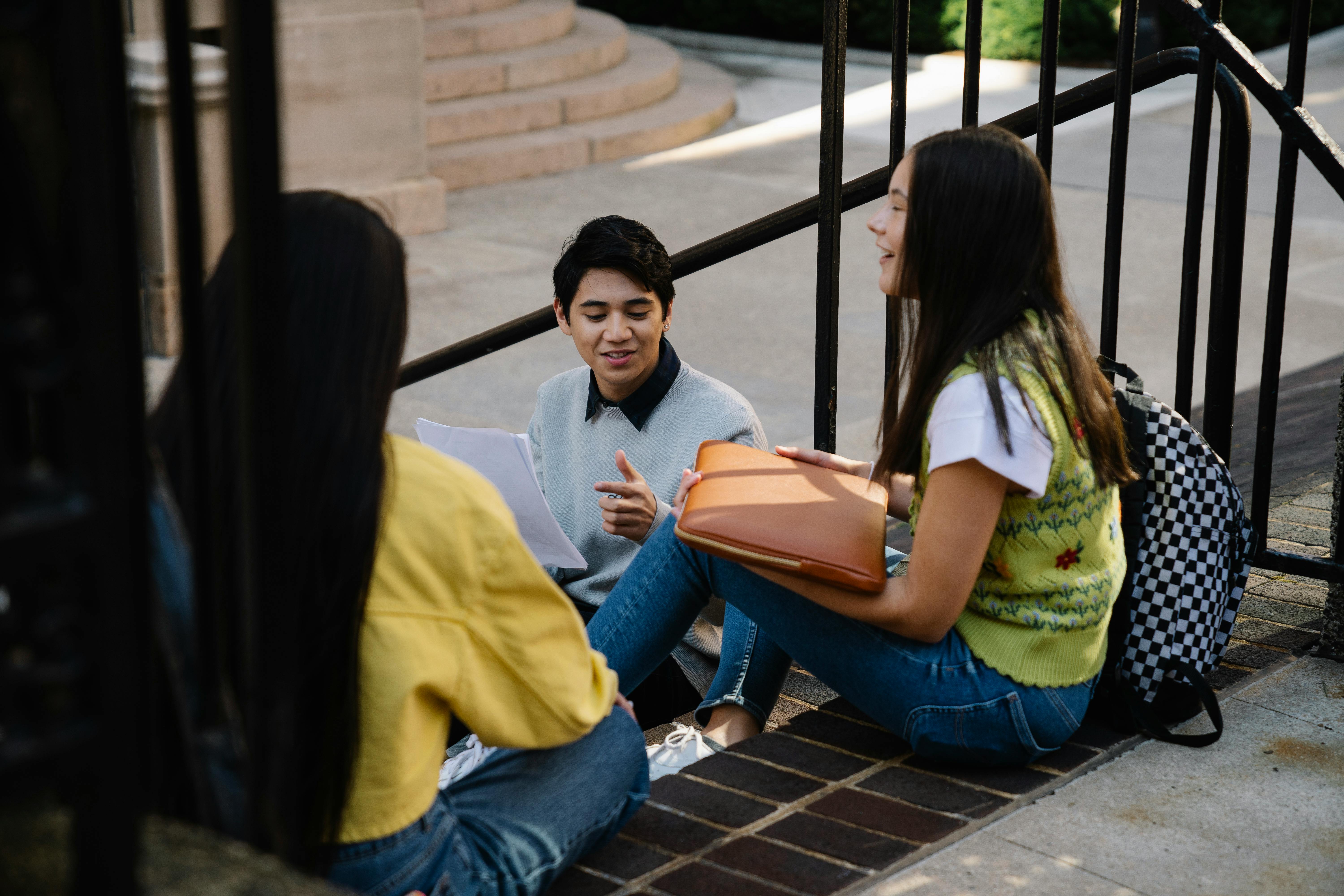 Group of diverse students with backpacks walking on a famous European university campus